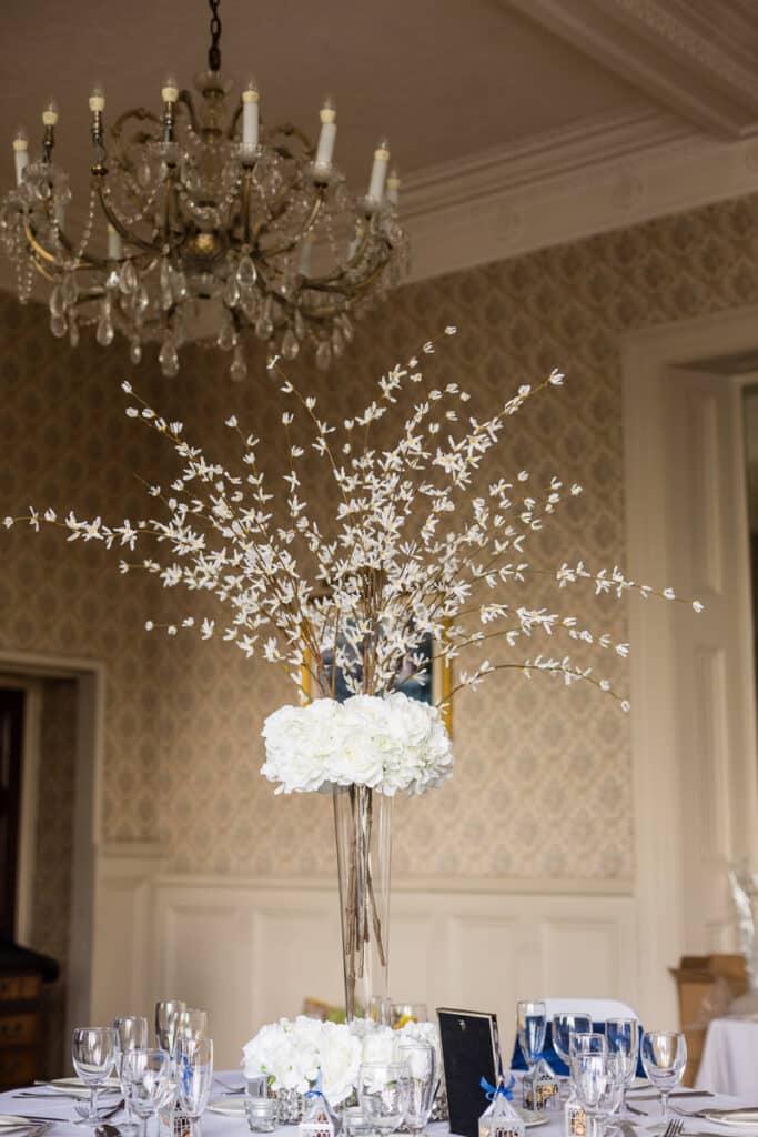 Hydrangeas and forsythias make an elegant arrangement in this tall tapered vase