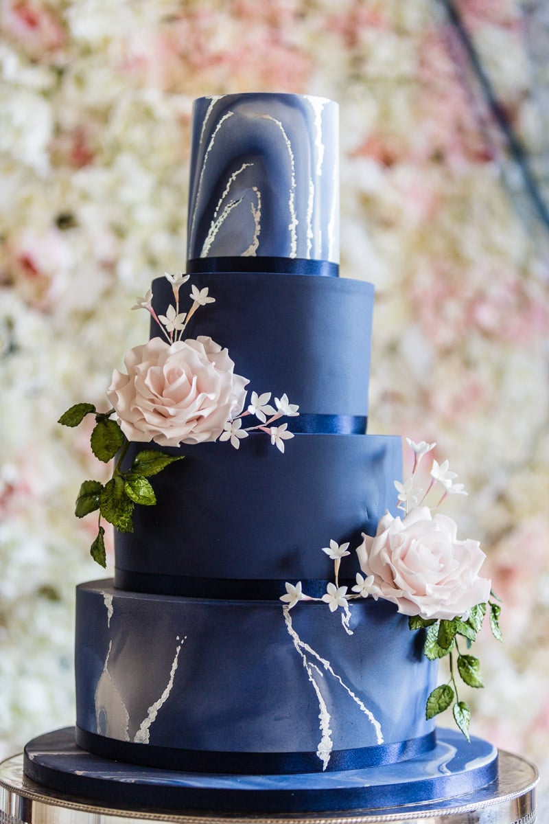 Wedding Cake and a flower wall backdrop