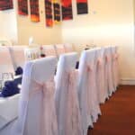 Baby pink lace sashes teamed with navy blue table runners make fabulous friends-FabulousFunctionsUK