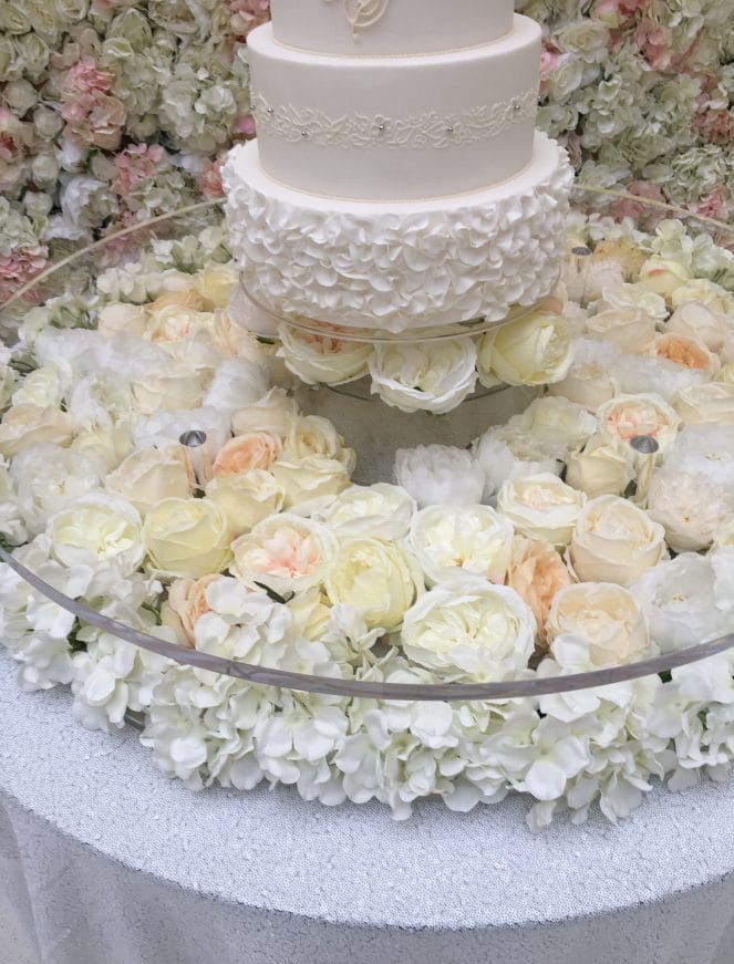 Roses, hydrangeas and peonies decorate the floating cake stand