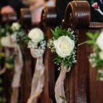 A Marriage Law Shake-Up - wooden church pews with flower decorations