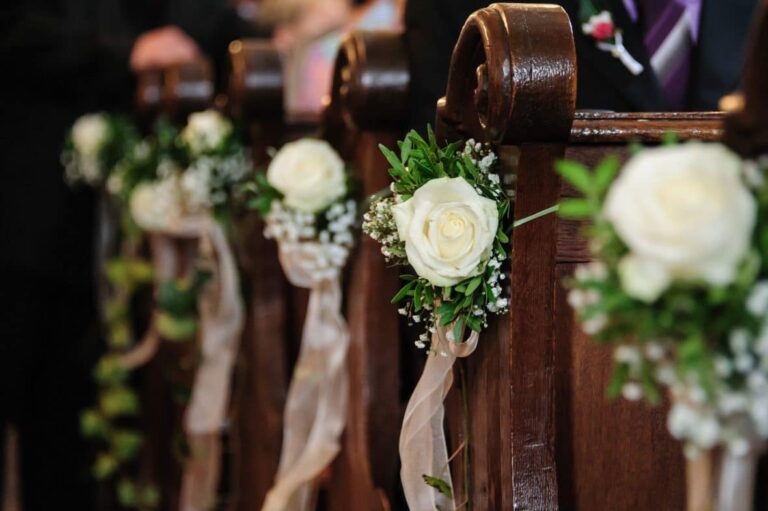Asking Guests to Pay to Attend Your Wedding - pews in a church with flowers on them