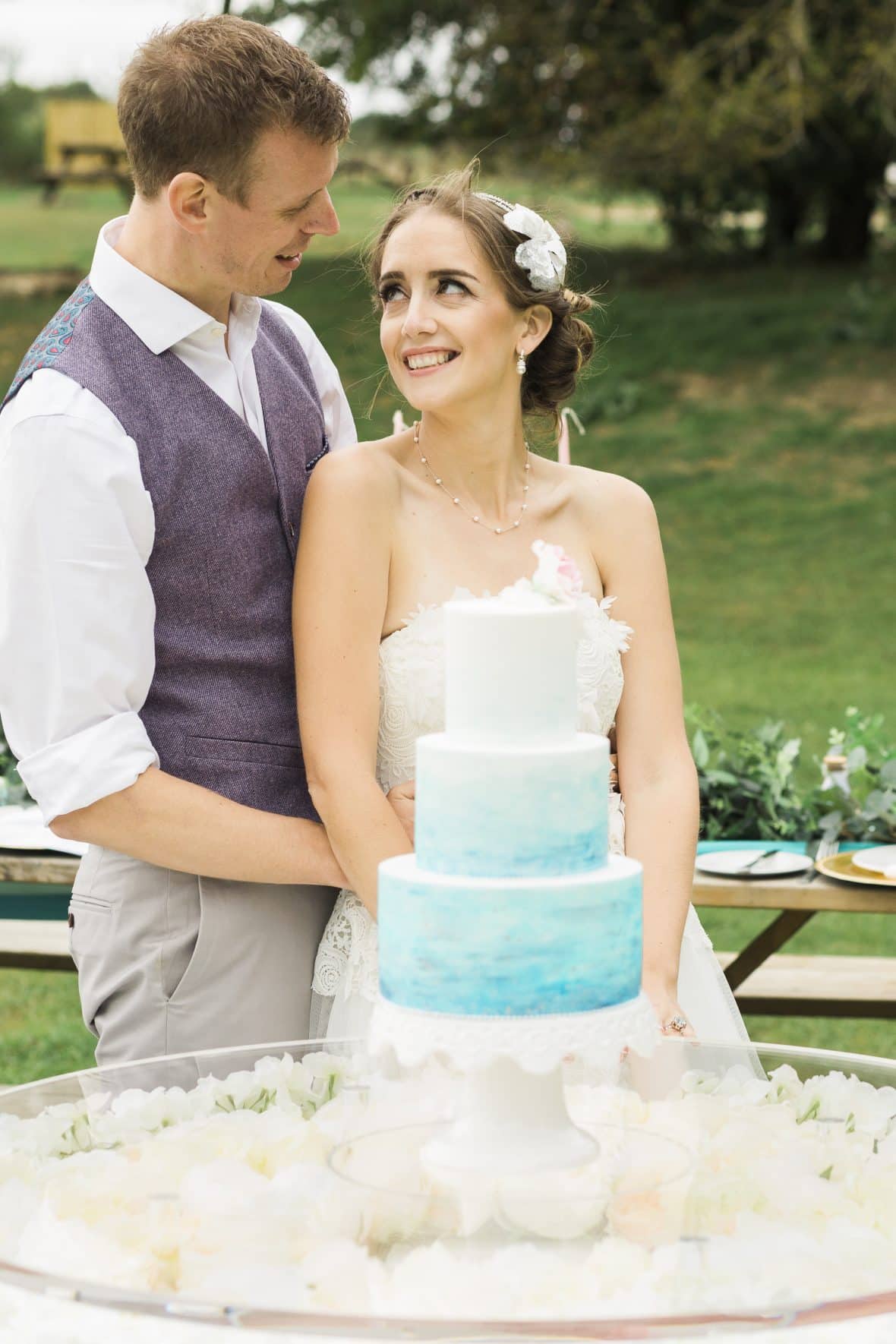 Bride and Groom with wedding cake on a floating cake table-Fabulous Functions UK