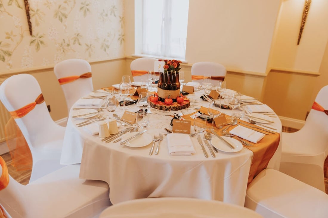 Autumn themed table decor using glorious rich rusts and golds to create a warm, welcoming wedding decor.