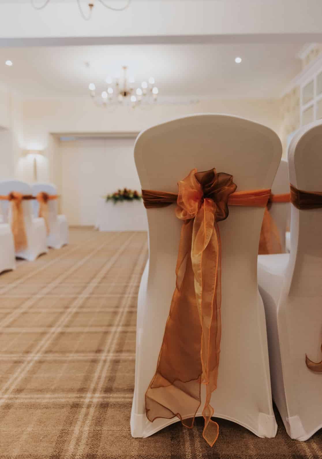 Shimmering organza sashes in golds and rusts to decorate the ceremony venue - An Autumn Themed Wedding