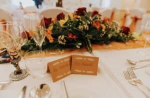 Bold Colours in Wedding Décor -Top table decor in autumn colours perfectly complements the venue styling. Look at the fabulous goblet provided by the bride and groom. SimTop table decor complements the autumn themed venue decor