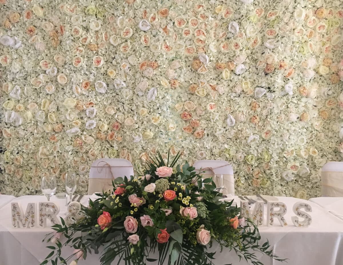 Wedding Backdrop- Peaches and Cream silk flower wall wedding backdrop from Fabulous Functions UK