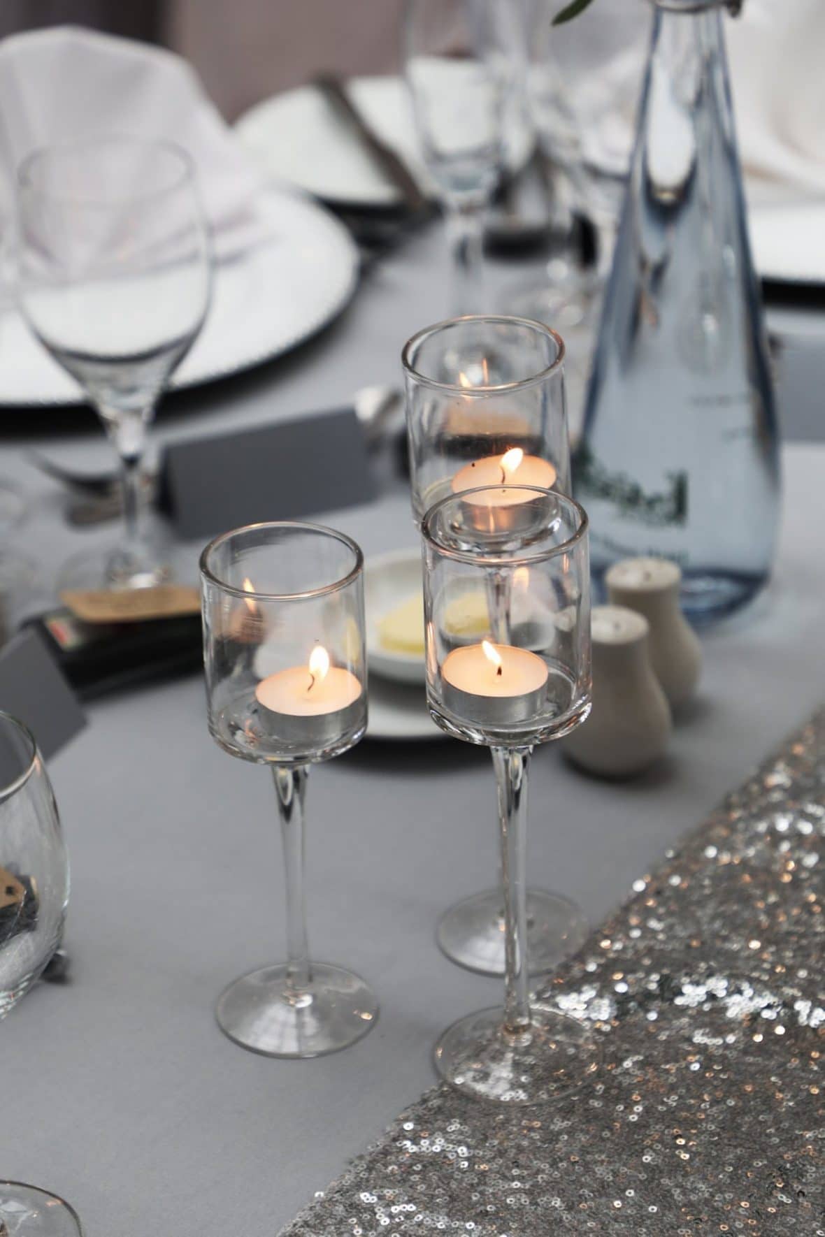 Staggered height glass tea light holders created warmth and brings a soft ambience to the decor