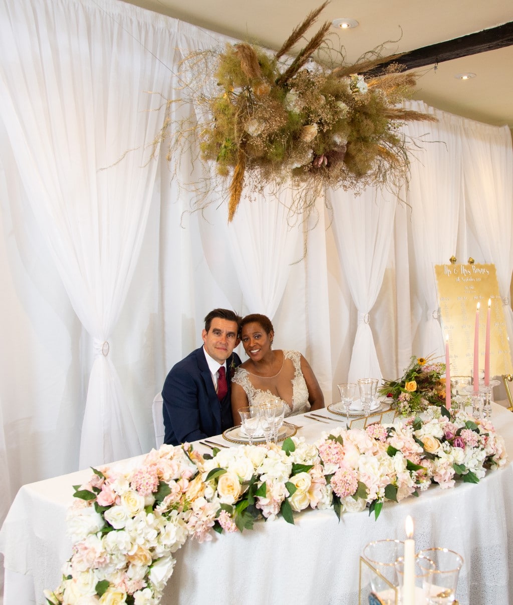 Sweetheart table with cascading floral garland - ombre themed wedding decor