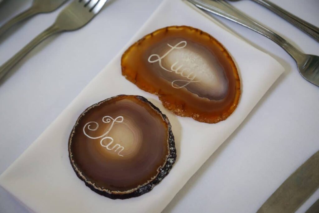 a rose gold wedding theme - Agate slice in natural tones serve as guest place names. The perfect wedding favour and memento for your guests. Available from Fabulous Functions UK