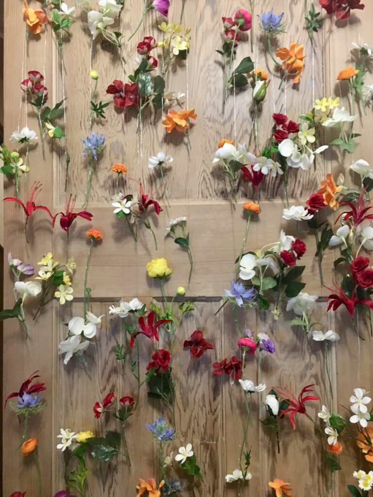 Are Budget Wedding Backdrops Cost Effective? - Flowers on wire forming a curtain.