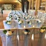A blue themed wedding decor for Leanne and Chris chose a baby blue organza sash to dress their chairs and each bow was adorned with a small posy in white and blue florals and foliage. The blue theme was continued in the centrepieces designs created by the team at Fabulous Functions UK.