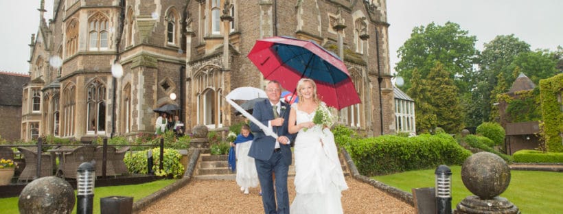 wedding party under umbrellas - 6 Wet Weather Wedding Planning Tips