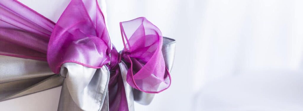 Platinum-and-fuschia-sash-combination-FabulousFunctionsUK-1180x435 -Chair Covers, Sashes and Chair Decorations