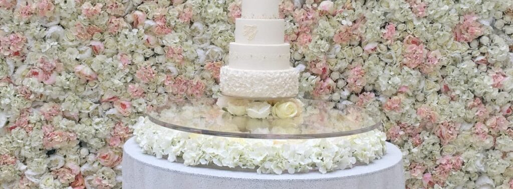 Flower wall with floating cake table in front of it