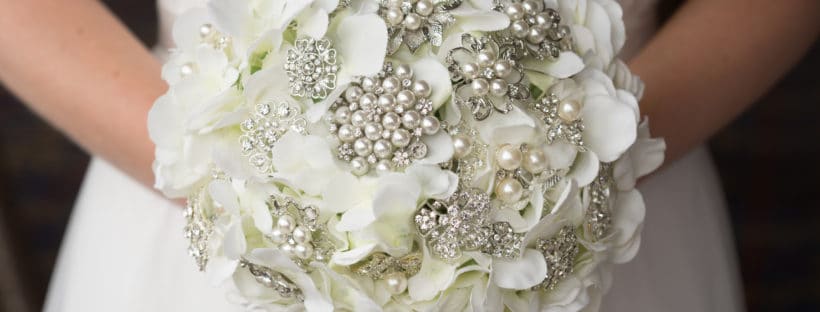A silver toned  brooch bouquet - Bridal  bouquet created with white silk hydrangeas and silver brooches.