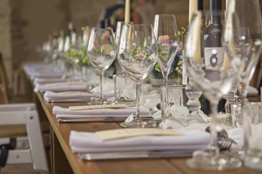 Banquet style table setting for a summer wedding. The flowers were created using a palette of blush pinks, blues and creams. 