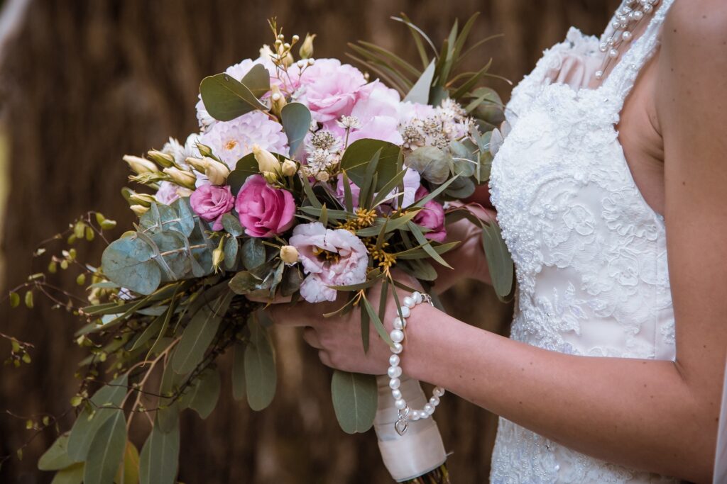 Hand-tied bouquets resemble a bouquet with flowers that has just been picked from the garden. This is a more relaxed style of bouquet.
This bridal bouquet incorporates a multitude of florals in tones of blush pinks, fuchsia and cream blooms.