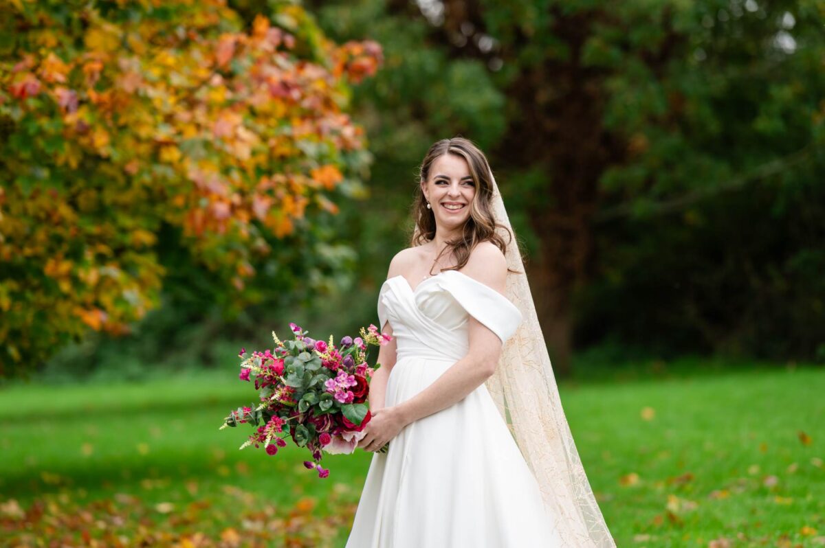 Bride with her beautiful silk bouquet in the grounds of the Peartree Purton