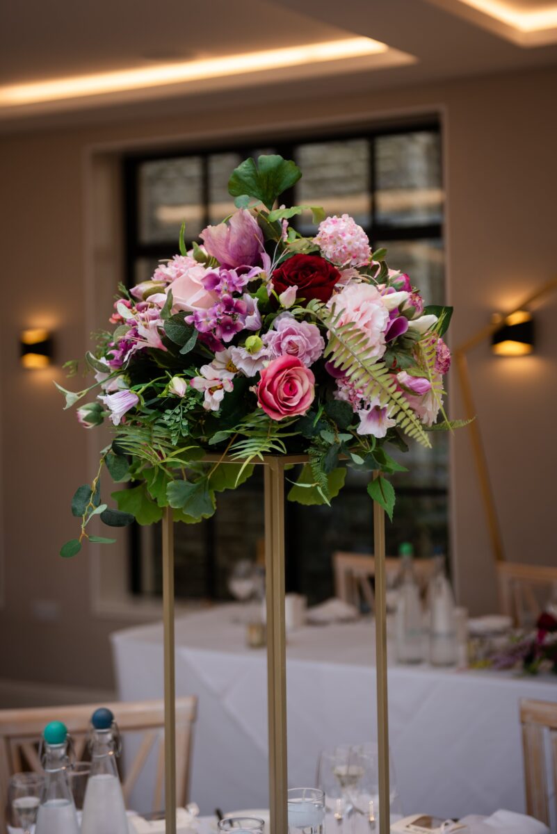 Silk Wedding flowers for this stunning guest table centrepiece at the Pear Tree Purton wedding venue   