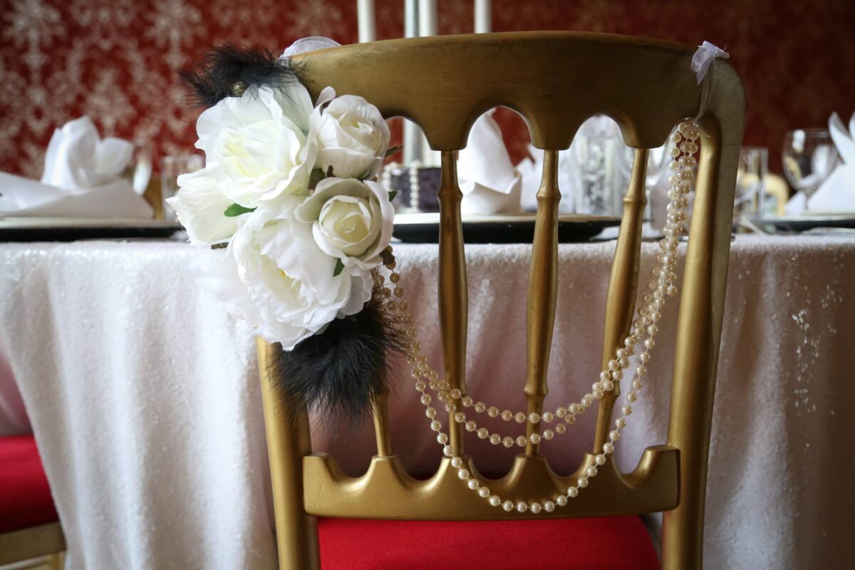 Rose and feathers chair decor for a vintage venue styling themed wedding decor 