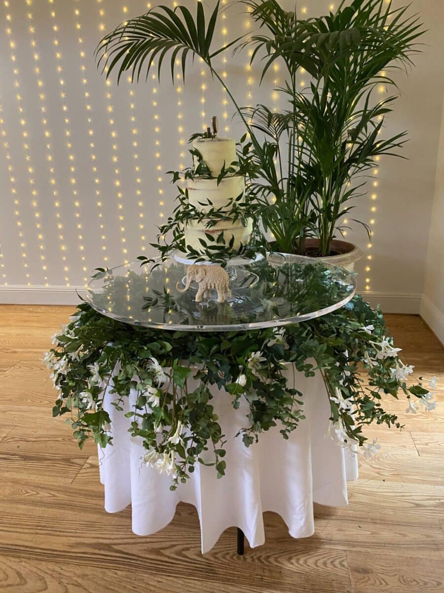 Acrylic cake table dressed with botanical themed setting- Hire from Fabulous Functions UK 07851 842451