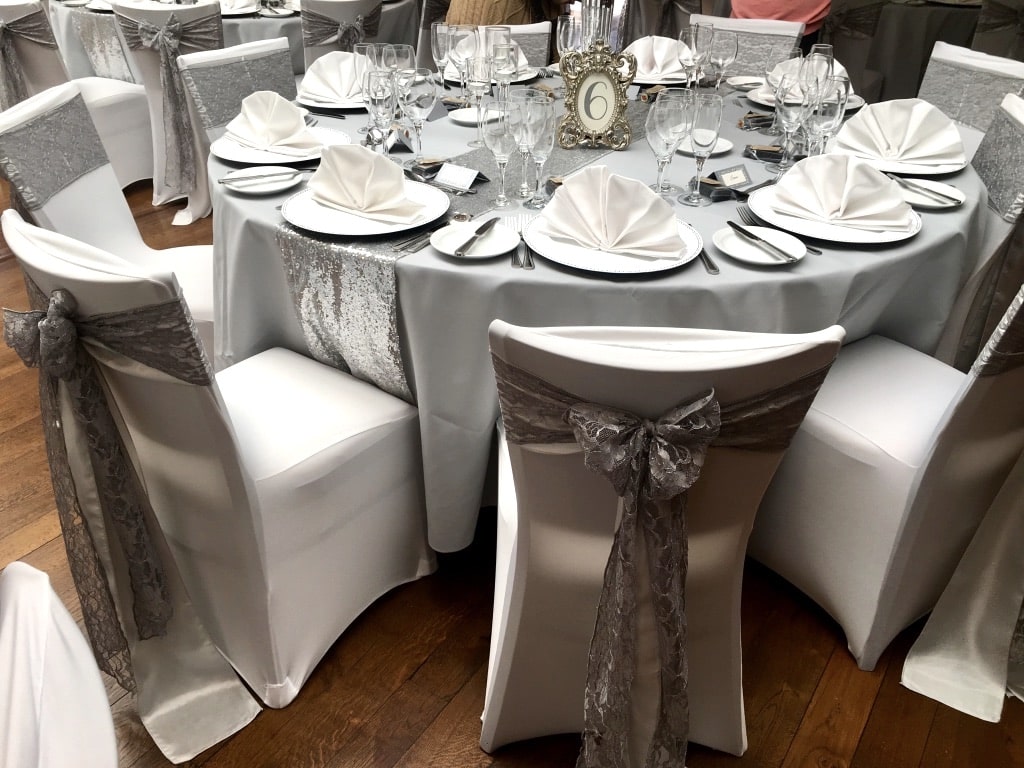 Platinum toned taffeta under lay sash with a silver toned lace sash  